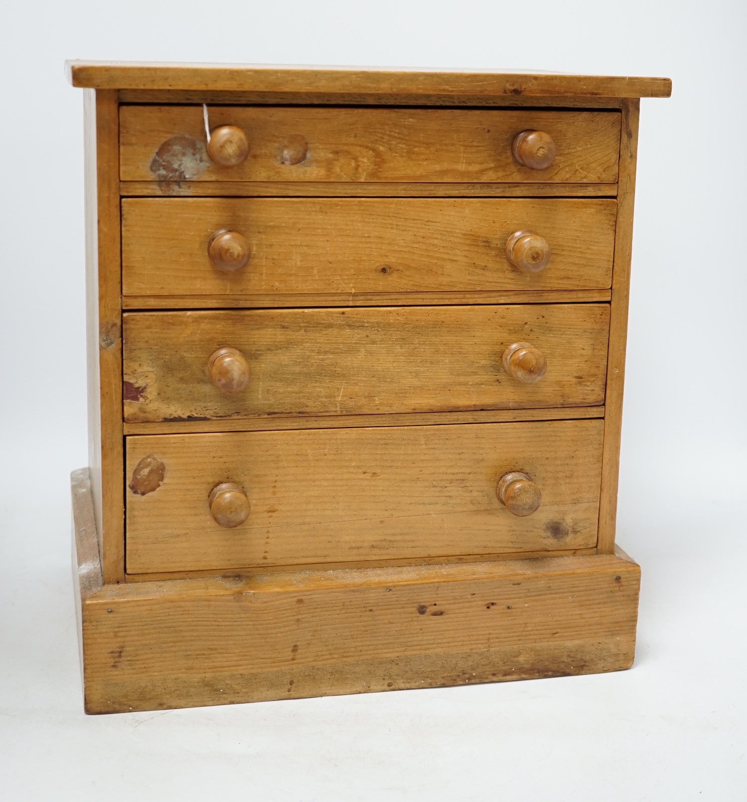 A pine miniature four drawer chest, 33cm high. Condition - poor to fair